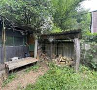 A family house in Branč with a woodshed, wood, a table, and a target in the yard.