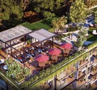 Rooftop garden with a terrace in a residential complex in Pattaya surrounded by greenery.