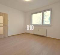 A bright room with wooden floors and a window in a 3-room apartment.