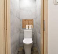 A toilet with a simple design in a 3-room apartment.