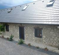 Stone family house in BOLDOGKOVARALJA with windows and a sloped roof.