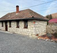 Stone family house with wooden windows and a sloped roof in Boldogkőváralja.