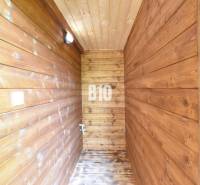 Wooden interior with wall lighting and wooden flooring in a cabin.