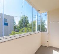 A glazed balcony in a 2-room apartment with a view of greenery in Dubnica nad Váhom.