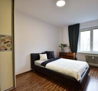 Bedroom in a 2-room apartment with a bed, built-in wardrobe, and window.