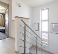 Family house with a staircase and entrance to the room, bright interior with decorations.