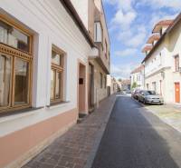 Vrátna Street in Košice, Old Town, with historic facades and parked cars.