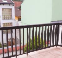 A balcony with a view of buildings, a 2-room apartment on Vrátna Street in Košice.