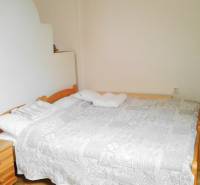 A bright bedroom with a double bed in a two-room apartment.