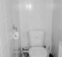 A bathroom in a 2-room apartment with tiled walls and basic equipment.