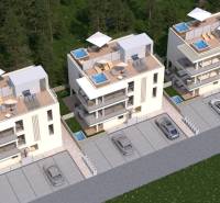 3 modern apartment buildings with terraces, jacuzzis, and parking, surrounded by greenery.