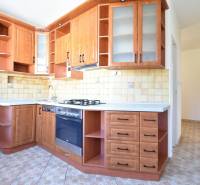 A kitchen with built-in cabinets and an oven in a 4-room apartment, tiles and light walls.