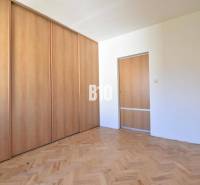 A room with a built-in wardrobe and wooden floor in a 4-room apartment.