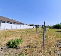 A plot with grass and a fence ready for living in Čierna Voda on Čierna Voda Street.