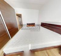 A bedroom in a 3-room apartment with a built-in wardrobe and a bed with a mattress.
