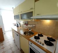 A kitchen in a 3-room apartment with a stove and a dishwasher.