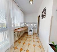 Bright loggia with a washing machine and a view in a 3-room apartment.