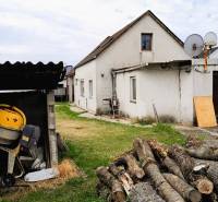 A family house in 2473 Potzneusiedl with wood and a concrete mixer in the yard.