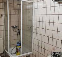 Bathroom with tiles and a shower in a family house.