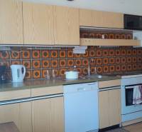 A kitchen in a family house with retro tiles and built-in appliances.