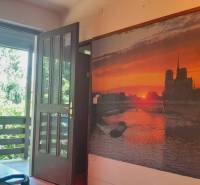 Open balcony, large-format painting with a sunset motif in a family house.