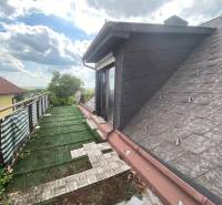 Attic terrace of a family house in Hundsheim with a view and a lawn area.