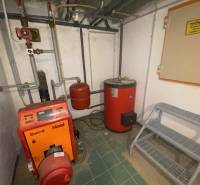 Boiler room in a family house with a boiler and a storage tank.
