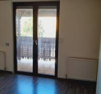A room with balcony doors and radiators, Apartment construction.