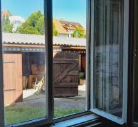 View from the window of a yard with a wooden shelter, Apartment construction.