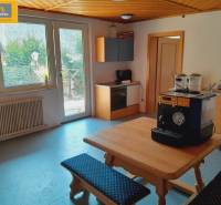 Interior of a gastro space with a wooden kitchen unit and a coffee machine on the table.