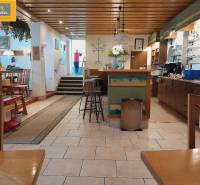 Gastro premises with a wooden ceiling, bar, and children's corner.
