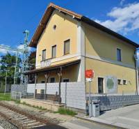 The yellow railway station building in St. Andrä am Zicksee with a train warning.
