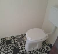 A restroom with a ceramic floor in commercial premises.