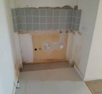 Space for kitchen appliance with tiling in commercial premises.
