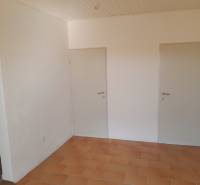 Interior of commercial premises with two white doors and tiles.