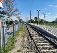 Train station in St. Andrä am Zicksee with tracks and a passenger on the platform.