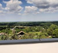 View from the villa in Hainburg an der Donau of the landscape with wind turbines and houses.