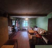 Rustic interior of a cottage with furniture and a sofa in a cozy space.