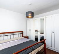 A bedroom with a wardrobe and a bed in a 2-room apartment.