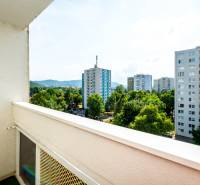 View from the balcony of a 2-room apartment in Humenné overlooking the housing estate and greenery.