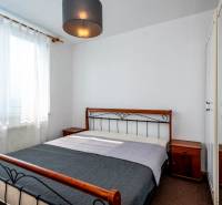 Bedroom in a 2-room apartment, comfortable bed, wardrobes, and nightstands.