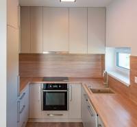 A kitchen in a family house with built-in cabinets, a sink, and a stove.