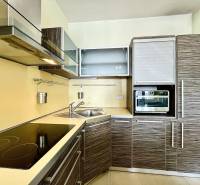 A kitchen in a 2-room apartment with a corner unit, a hob, and built-in appliances.