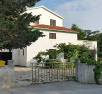 A family house in Vrsi with a white facade, red roof, and surrounding greenery.