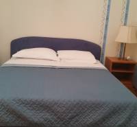 Bedroom in a family house, with a double bed and nightstands.