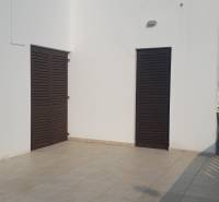 The family house in Vrsi has a terrace with white walls and wooden shutters.