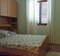 Cozy bedroom with built-in wardrobes and a bed in a family house.