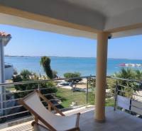 View from a family house in Vrsi of the sea and harbor with greenery.