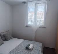 Bedroom with a double bed and a wardrobe, in a family house.