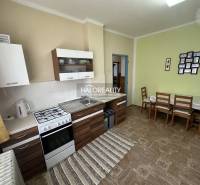 A family house with an interior staircase, wooden door frames, and carpet.
